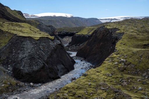 Meltwater from the south cuts through many meters of sediment, July 2023.