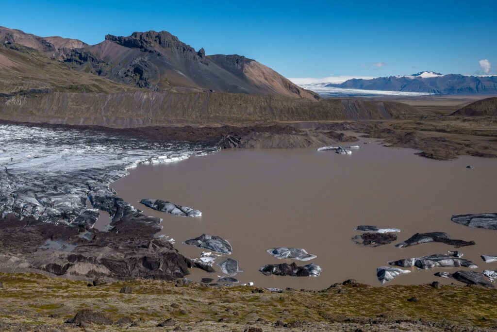 The lake expands as the glacier retreats.