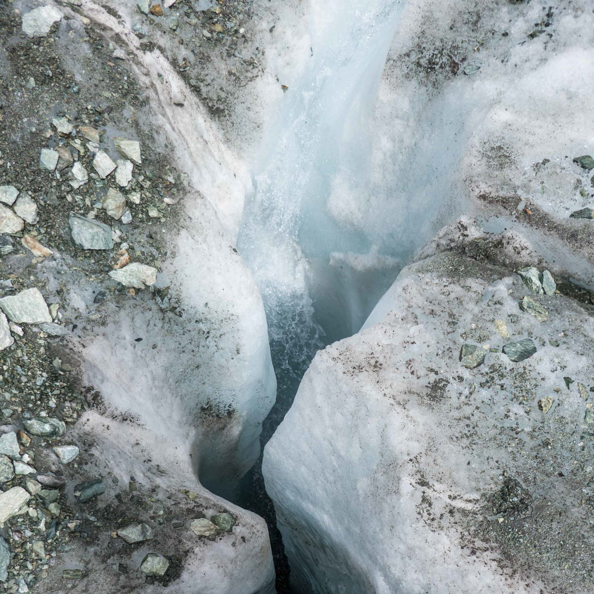 Meltwater dives into a moulin to reach the glacier bed.