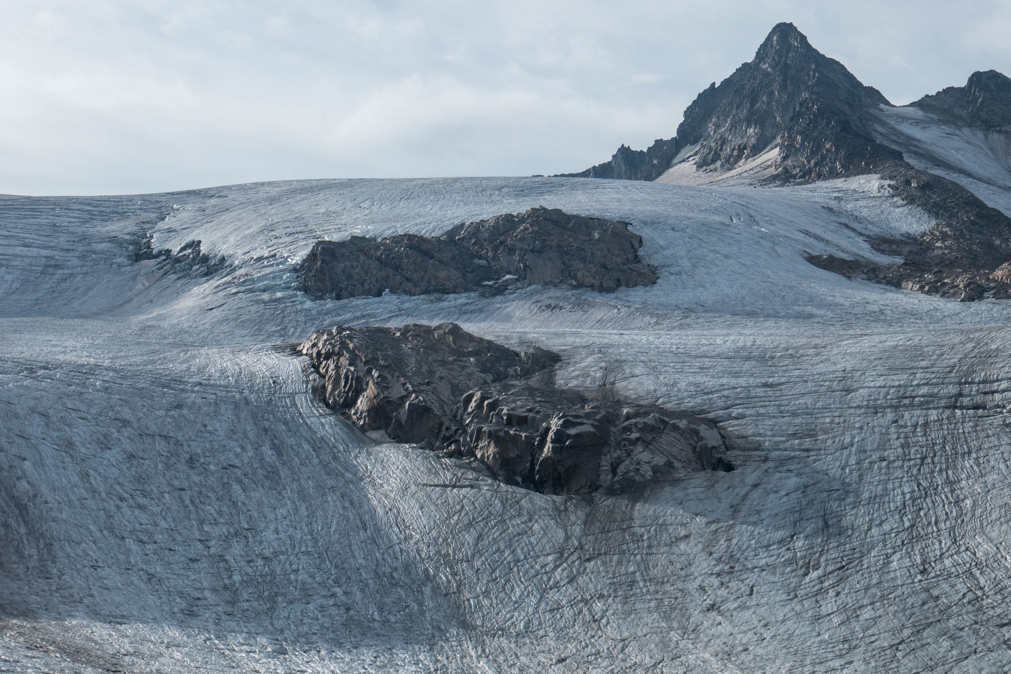 Rocks are prodruding the ice, accelerating melt.