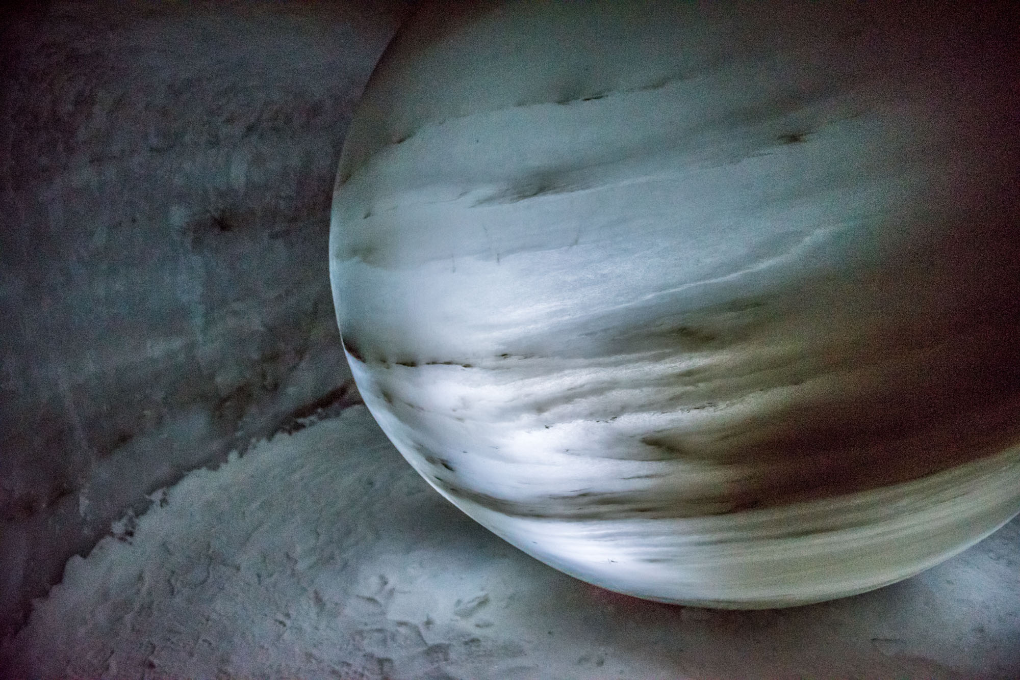 A globe of thousands of years old ice. The dark bands are accumulated dust and reindeer dung.