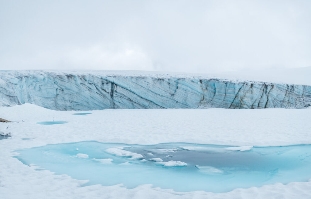 In the southwest, Spørteggbreen disintegrates above a lake.