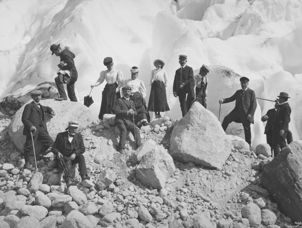 Upper class tourists on the moraine next to Briksdalsbreen in 1906. Source: Anders Beer Wilse, National Library of Norway photo NF_W_04663.