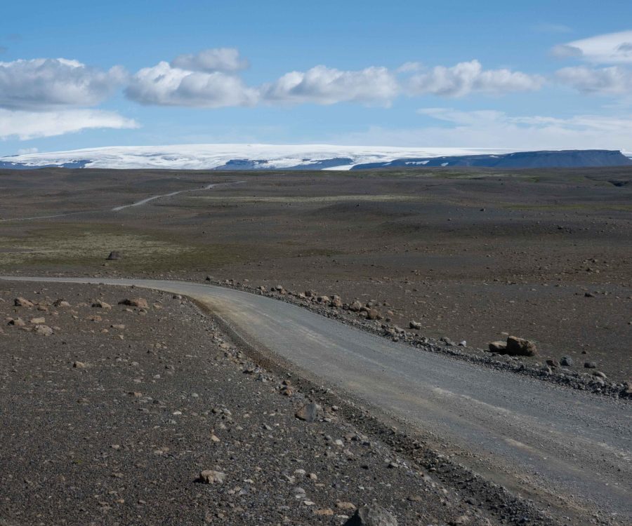 Road F35 winds its way through a barren landscape with Hofsjökull in the background, July 2023.